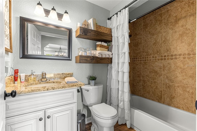 bathroom with a textured wall, shower / bathtub combination with curtain, toilet, and vanity