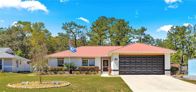 ranch-style house with stucco siding, a garage, concrete driveway, a front yard, and metal roof