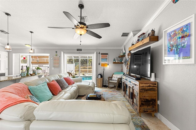 living room with visible vents, ornamental molding, a textured ceiling, ceiling fan, and a textured wall