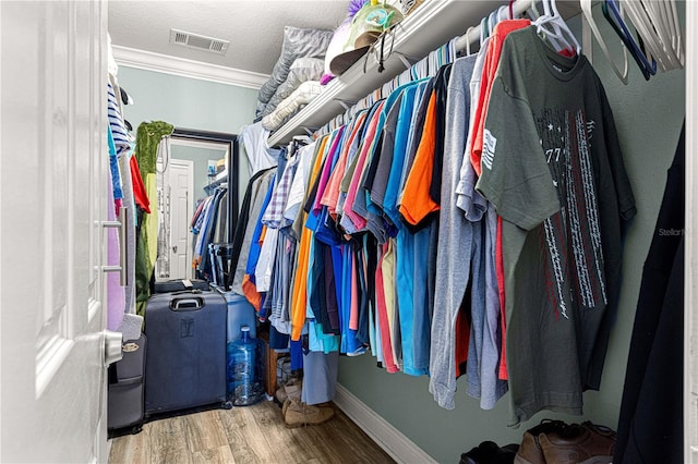 spacious closet with visible vents and wood finished floors