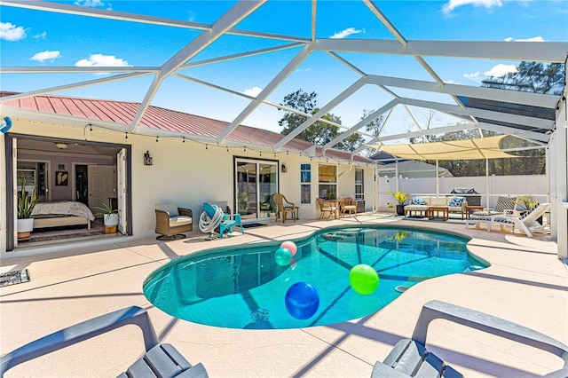 view of swimming pool with a fenced in pool, fence, glass enclosure, outdoor lounge area, and a patio