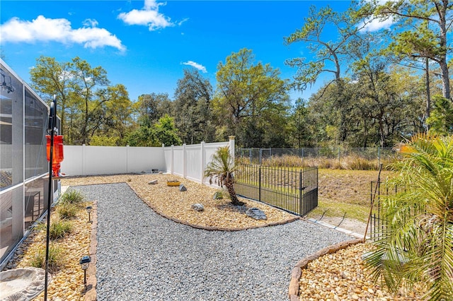 view of yard featuring a lanai and a fenced backyard