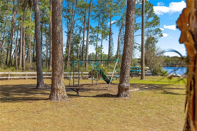 community jungle gym with a yard and a water view