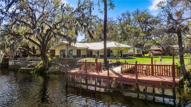 dock area featuring a water view and a lawn