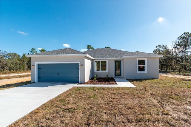 ranch-style house featuring a garage, a shingled roof, driveway, stucco siding, and a front yard