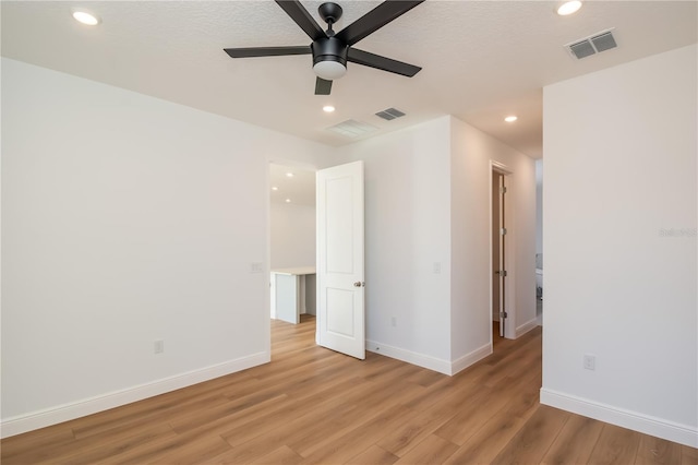 unfurnished bedroom with light wood-style floors, visible vents, and baseboards