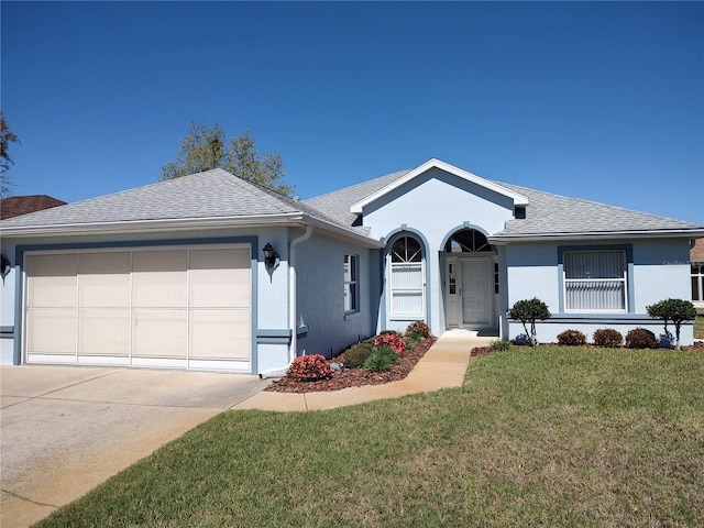 ranch-style house featuring a garage, a shingled roof, concrete driveway, stucco siding, and a front yard