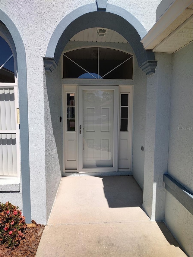 entrance to property with stucco siding