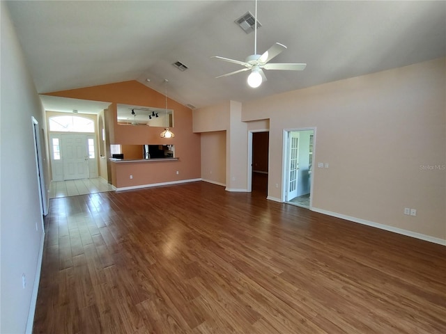 unfurnished living room featuring high vaulted ceiling, ceiling fan, visible vents, and wood finished floors