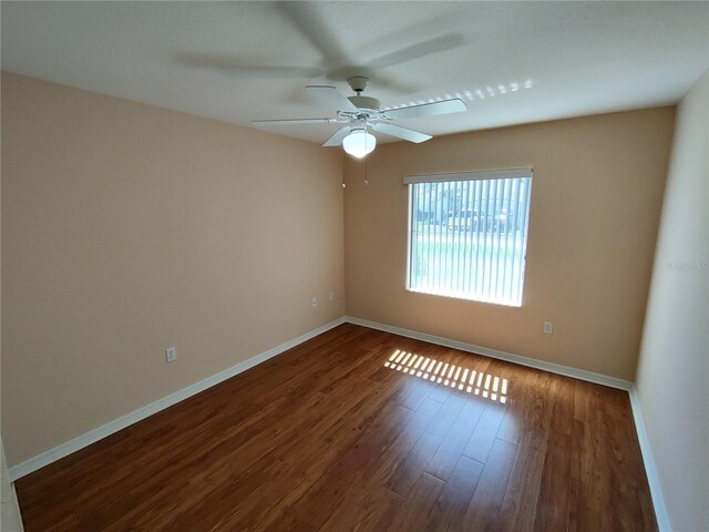 unfurnished room with ceiling fan, baseboards, and wood finished floors