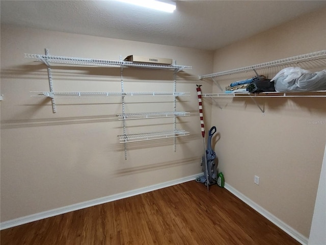 spacious closet with wood finished floors