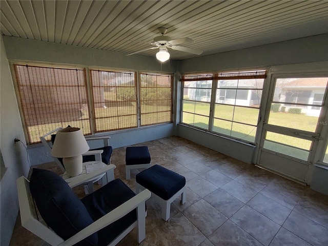 unfurnished sunroom with ceiling fan and wood ceiling