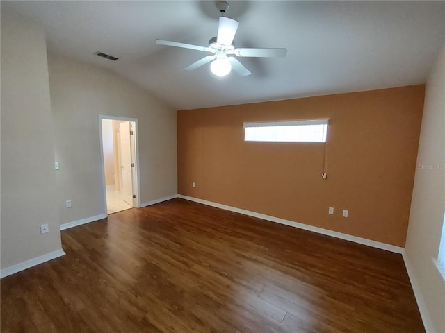 empty room with baseboards, visible vents, ceiling fan, wood finished floors, and vaulted ceiling