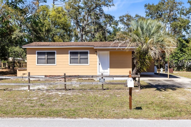 view of front of house with entry steps, a front lawn, and a fenced front yard