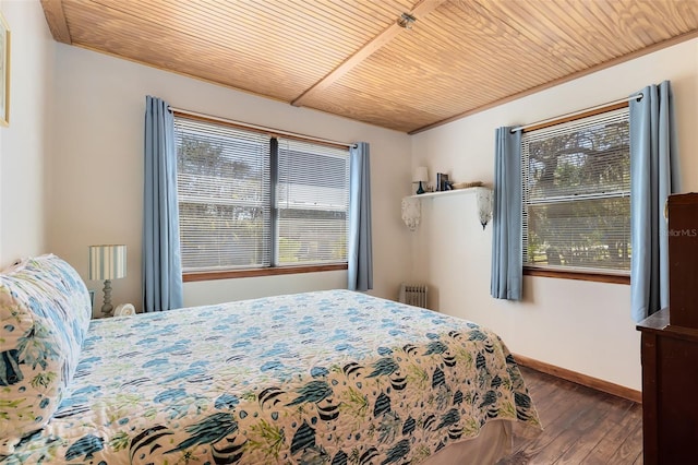 bedroom with radiator heating unit, wood ceiling, baseboards, and hardwood / wood-style floors