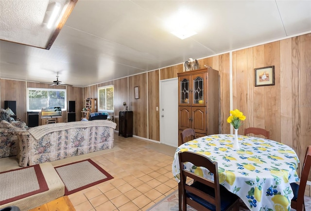 interior space featuring light tile patterned floors and wood walls