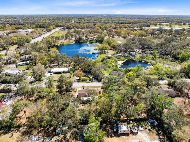 drone / aerial view featuring a water view and a view of trees