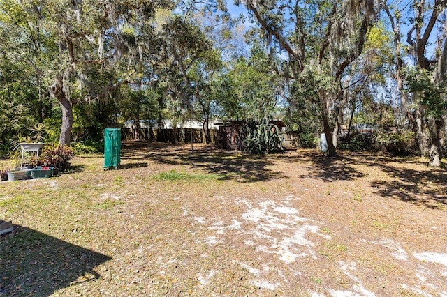 view of yard featuring a storage shed and an outbuilding