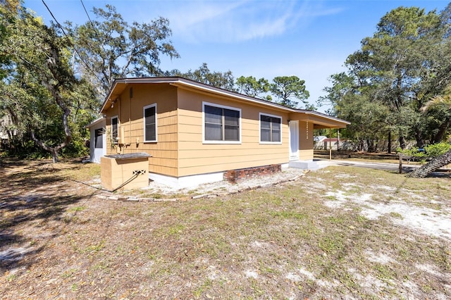 view of home's exterior with driveway and an attached carport