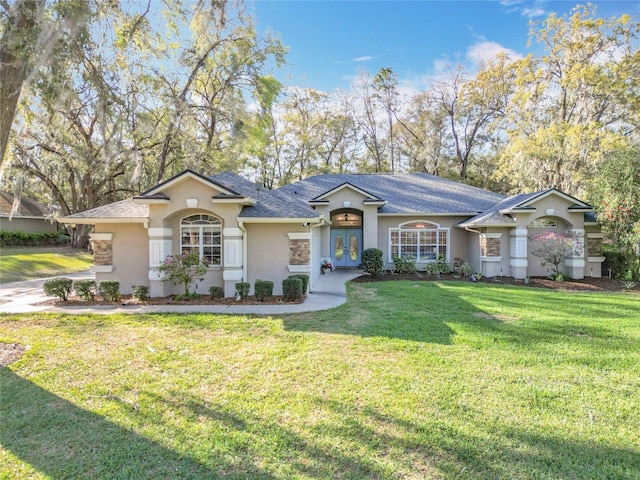 view of front of house featuring french doors, a front lawn, and stucco siding