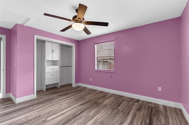 unfurnished bedroom with ceiling fan, a closet, baseboards, and wood finished floors