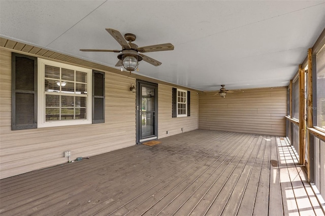 wooden terrace featuring ceiling fan