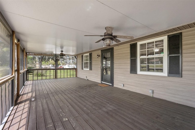 wooden terrace featuring a ceiling fan