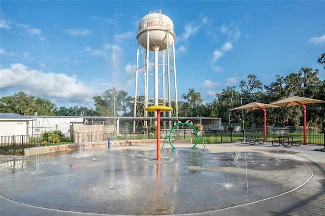 view of community featuring playground community and fence