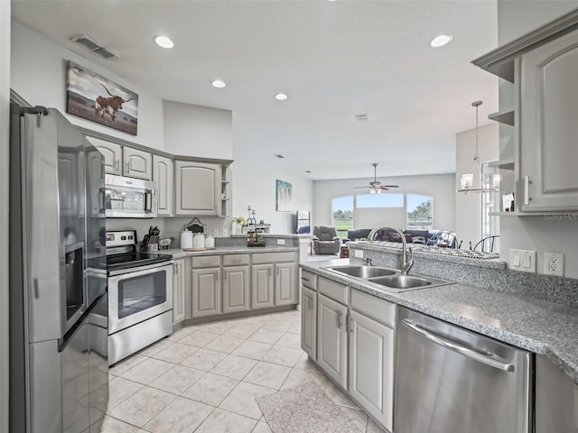 kitchen with visible vents, appliances with stainless steel finishes, gray cabinets, and a sink