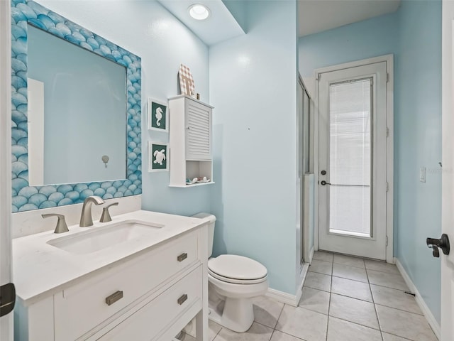 full bath featuring vanity, a stall shower, tile patterned flooring, and toilet