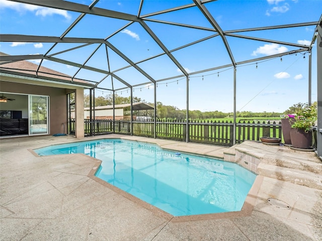 view of swimming pool featuring a fenced in pool, a lanai, a patio, and fence