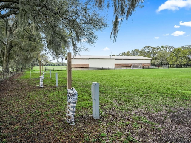 view of yard with a rural view and fence