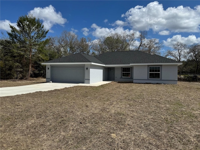 single story home with a garage, concrete driveway, and stucco siding