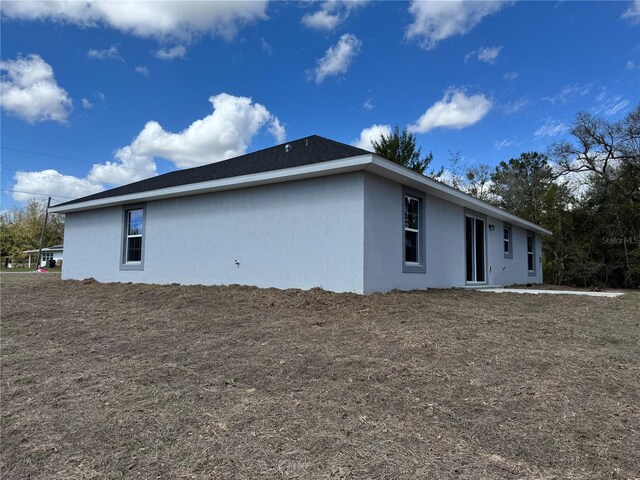 view of side of home with stucco siding