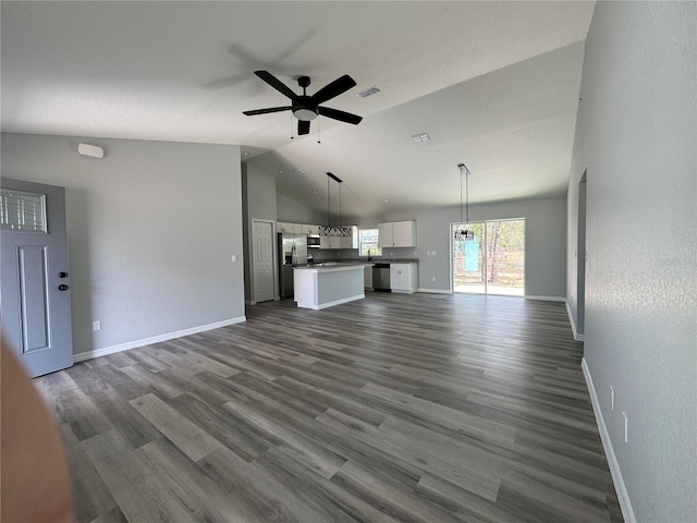 unfurnished living room featuring dark wood finished floors, lofted ceiling, visible vents, ceiling fan, and baseboards