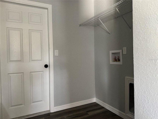 clothes washing area with hookup for a washing machine, dark wood-style flooring, laundry area, and baseboards