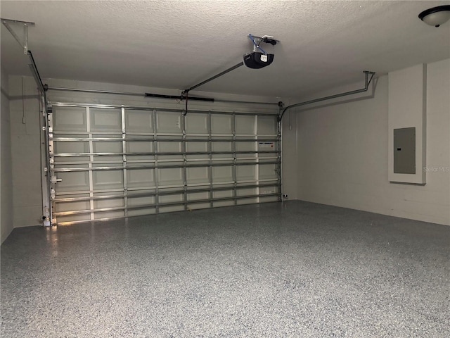 garage with a garage door opener and electric panel