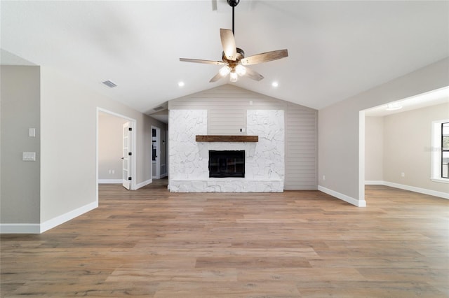 unfurnished living room featuring vaulted ceiling, wood finished floors, visible vents, and a ceiling fan