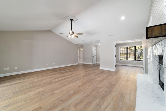 unfurnished living room featuring a fireplace, a ceiling fan, baseboards, vaulted ceiling, and light wood-style floors