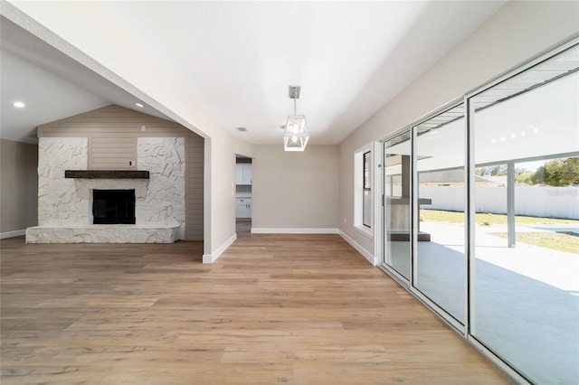 unfurnished living room featuring a fireplace, light wood finished floors, recessed lighting, visible vents, and baseboards