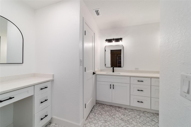 bathroom with baseboards, visible vents, and vanity