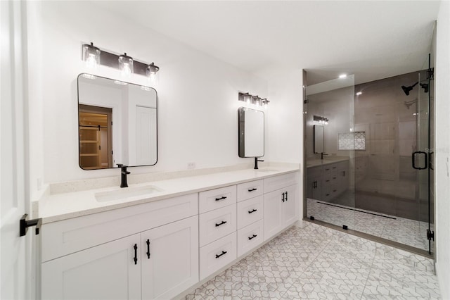 bathroom featuring a sink, a shower stall, and double vanity