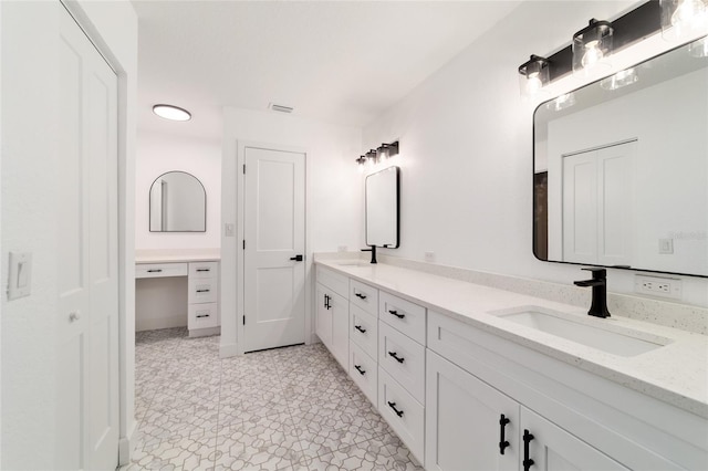 bathroom featuring double vanity, a sink, and visible vents