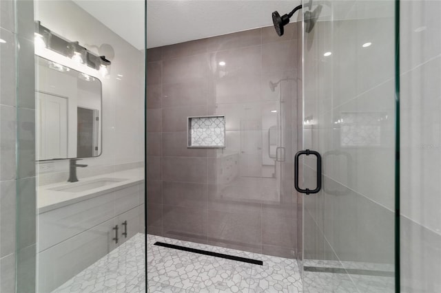 full bathroom featuring a stall shower and vanity