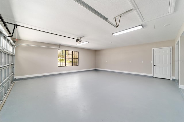 garage with baseboards and a garage door opener