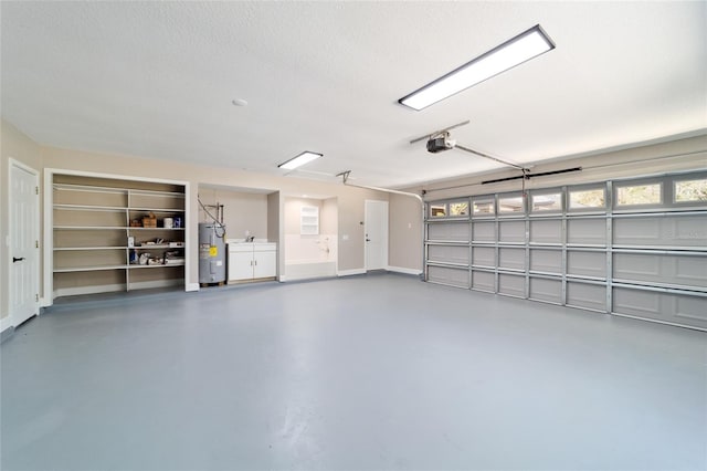 garage featuring a garage door opener and electric water heater