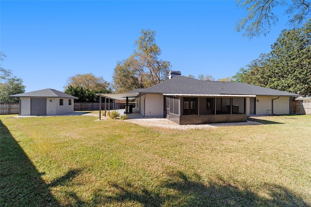 back of house with a sunroom, a yard, and fence