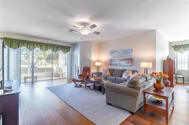 9458 SW 93rd Loop, Ocala, FL 34481 - living area featuring wood finished floors, a ceiling fan, and a textured ceiling