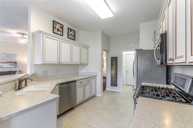 9458 SW 93rd Loop, Ocala, FL 34481 - kitchen featuring appliances with stainless steel finishes, light countertops, a ceiling fan, and light tile patterned floors