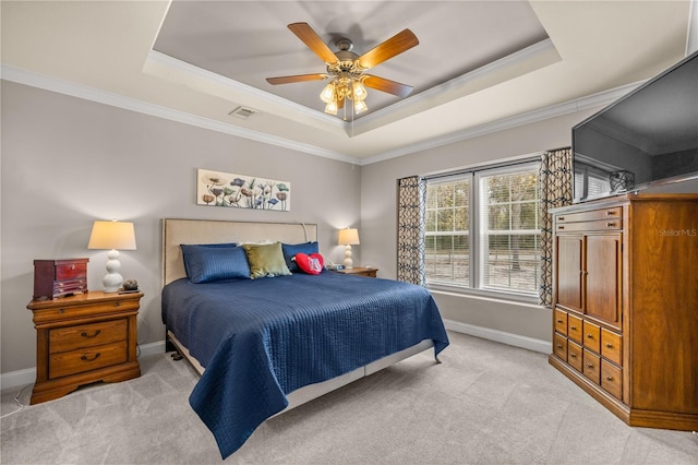 bedroom with light carpet, visible vents, a raised ceiling, and baseboards